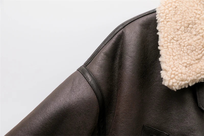 Women's leather winter jacket with vintage design and adjustable belt.