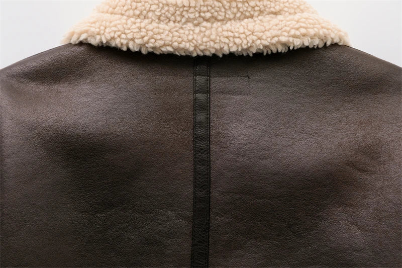 Women's leather winter jacket with vintage design and adjustable belt.