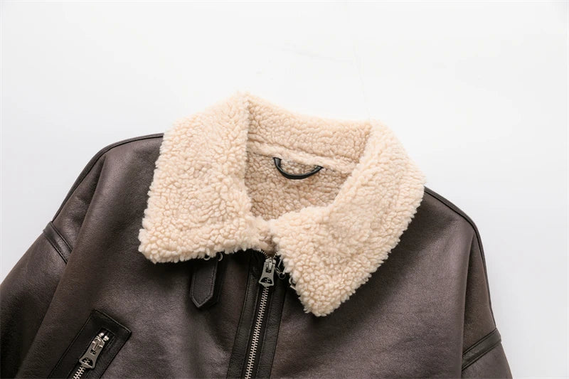 Women's leather winter jacket with vintage design and adjustable belt.